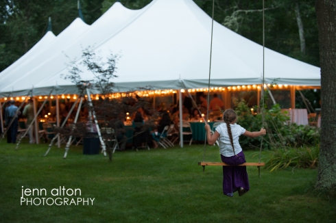 Tent reception and child on swing looking on, Cape Cod Wedding