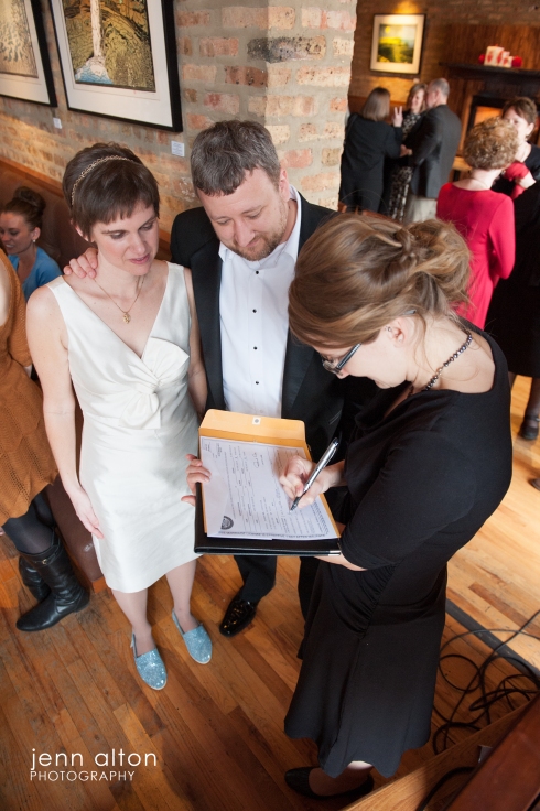 Bride, groom and officiant, Signing offical paperwork,  Uncommon Ground on Devon, Chicago, IL. 