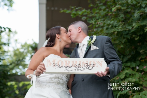 Bride and groom with custom sign portrait